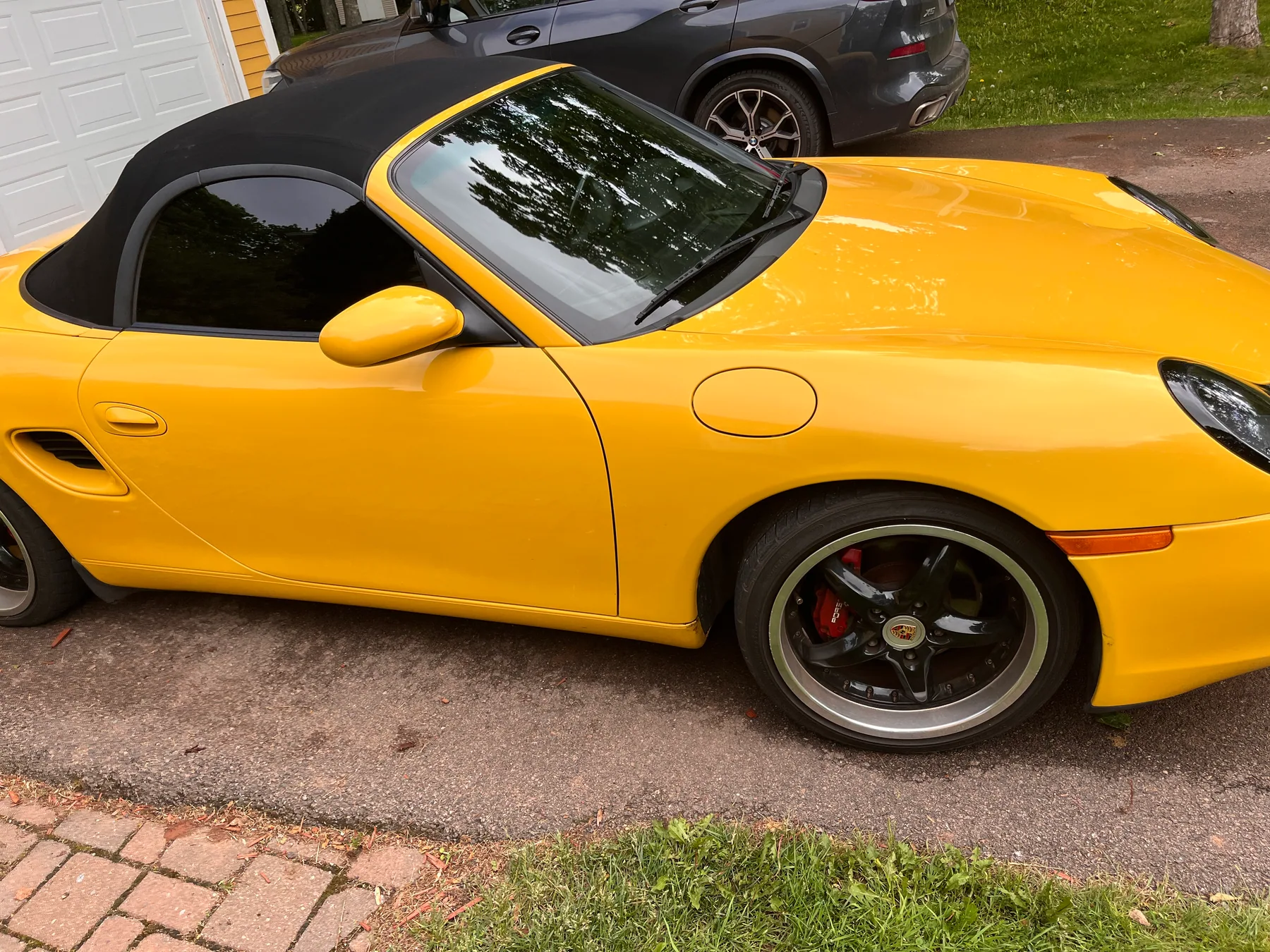 Yellow Porsche Boxster photographed from the side after detailing